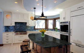 Kitchen with White Cabinets and Wood Island