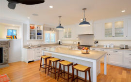 Kitchen with White Cabinets Wood Floors Gray Countertops