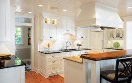 Remodeled kitchen with white cabinets and backsplash